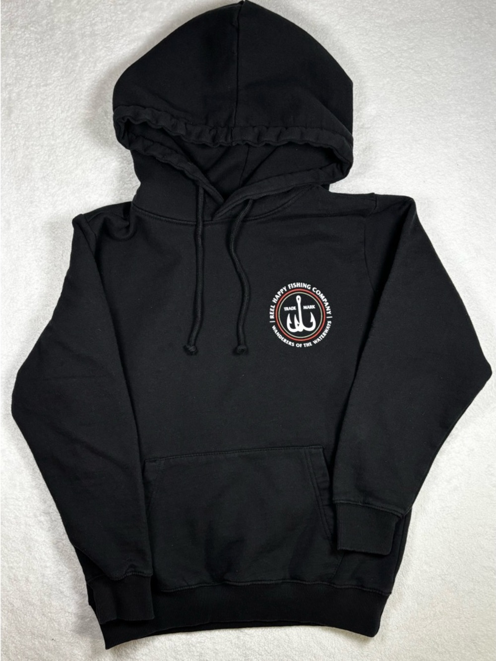 Reel Happy black hoodie with chest logo and vibrant back fish graphic, size S